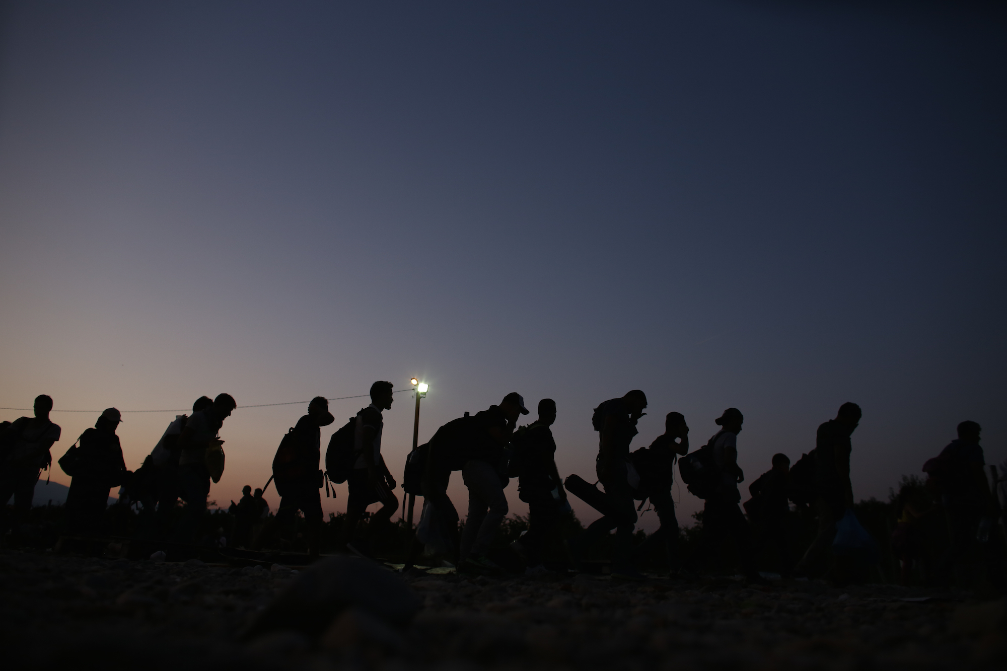Refugees at the Greek / FYR of Macedonia border on August 31. 2015. On a daily basis thousands of refugees pass the border to get a train, bus or taxi to Serbia