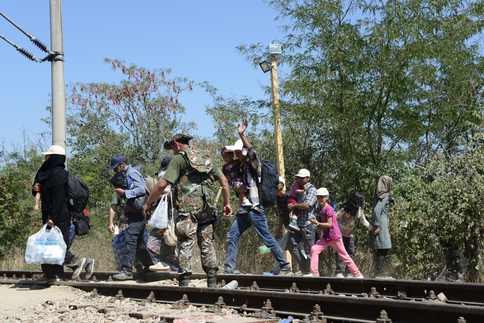 Soldiers, Police and Refugees at Eidomeni on the Greek border to FYR Macedonia The train railroad is a atypical borderstation for refugees. Other people are not allowed to pass. In Eidomeni/Gevgelija on September 1. 2015