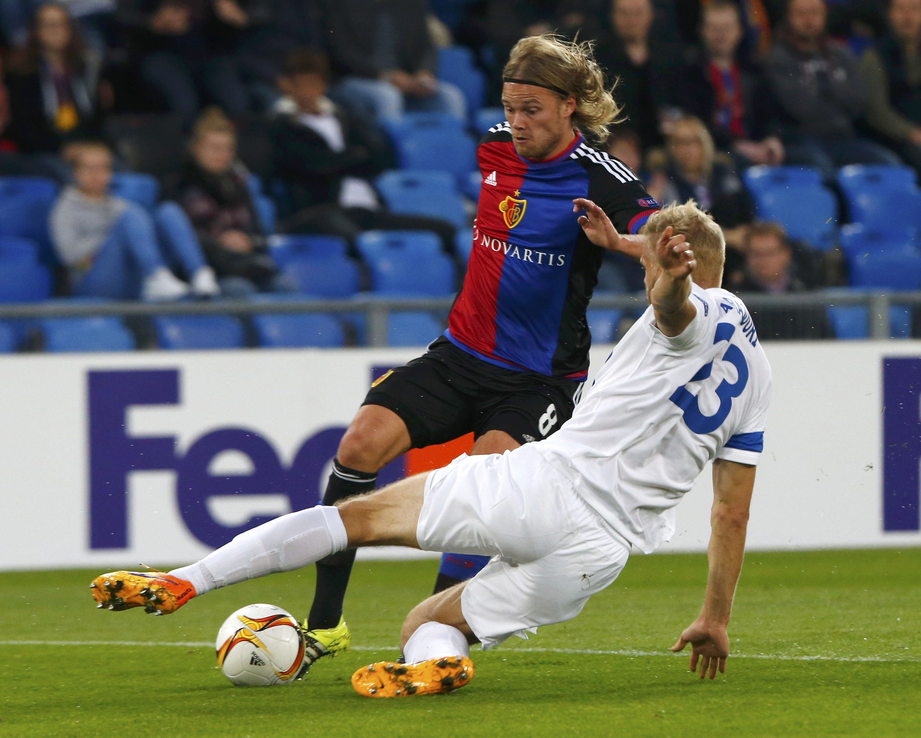 FC Basel's Birkir Bjarnason (L) fights for the ball with Lech Poznan's Paulus Arajuuri during their Europa League soccer match at the St. Jakob Park stadium in Basel, Switzerland October 1, 2015. REUTERS/Arnd Wiegmann