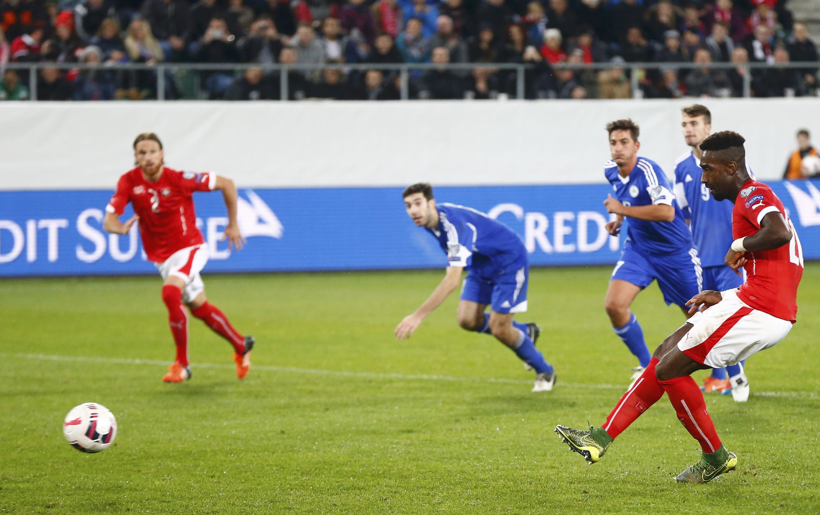 Switzerland?s Johan Djourou (R) scores a penalty against San Marino's goalkeeper Aldo Simoncini during their Euro 2016 Group E qualifying soccer match in St. Gallen, Switzerland October 9, 2015. REUTERS/Arnd Wiegmann