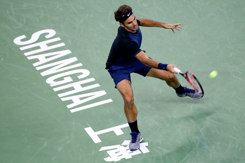 <p>Roger Federer of Switzerland hits a return shot while playing against Albert Ramos-Vinolas of Spain during their men's singles match at the Shanghai Masters tennis tournament in Shanghai, China Tuesday Oct. 13, 2015. (Chinatopix via AP) CHINA OUT</p>