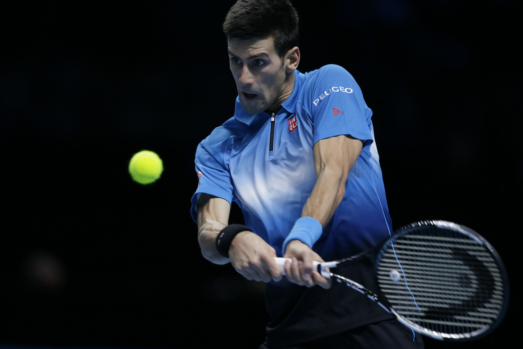 Serbia's Novak Djokovic plays a return to Japan's Kei Nishikori during their ATP World Tour Finals tennis match at the O2 Arena in London, England, Sunday Nov. 15, 2015. (AP Photo/Tim Ireland)