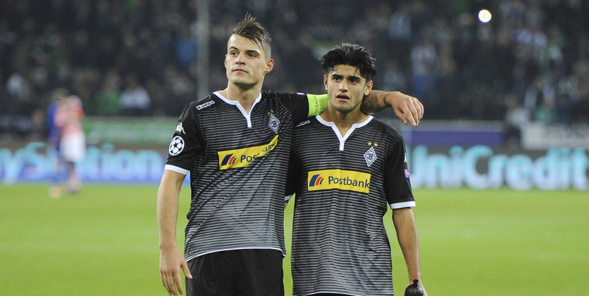 Moenchengladbach's Granit Xhaka, left, hugs his teammate Mahmoud Dahoud during the Champions League Group D soccer match between Borussia Moenchengladbach and Juventus Turin in Moenchengladbach, western Germany, Tuesday, Nov. 3, 2015. (AP Photo/Sebastian Konopka)