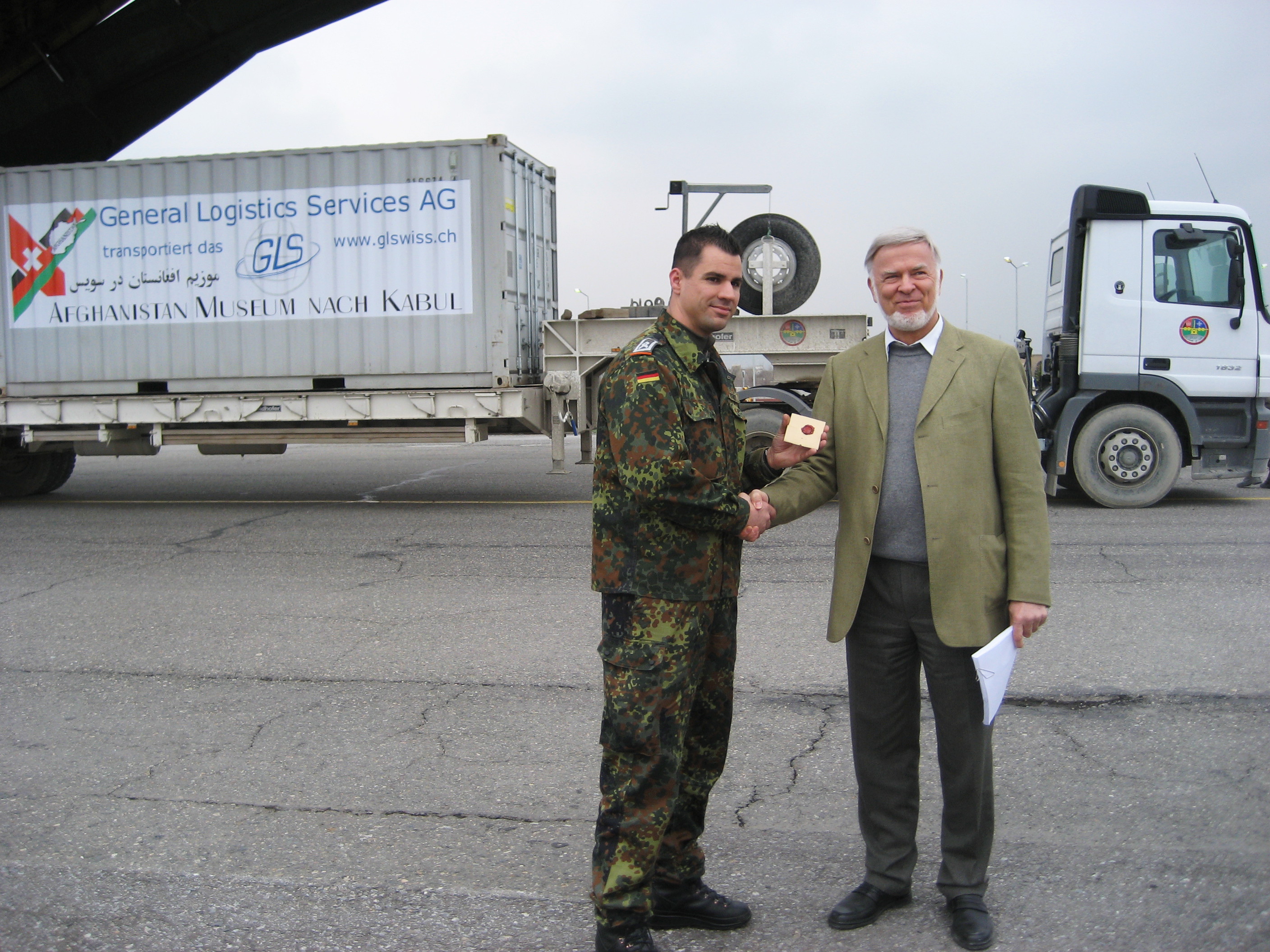 <p>Rücktransport des 'Afghanistan-Museums im Exil' durch die deutsche Bundeswehr. Übergabe des versiegelten Schlüssels für den Container durch den Begleitoffizier an P. Bucherer. März 2007.</p>