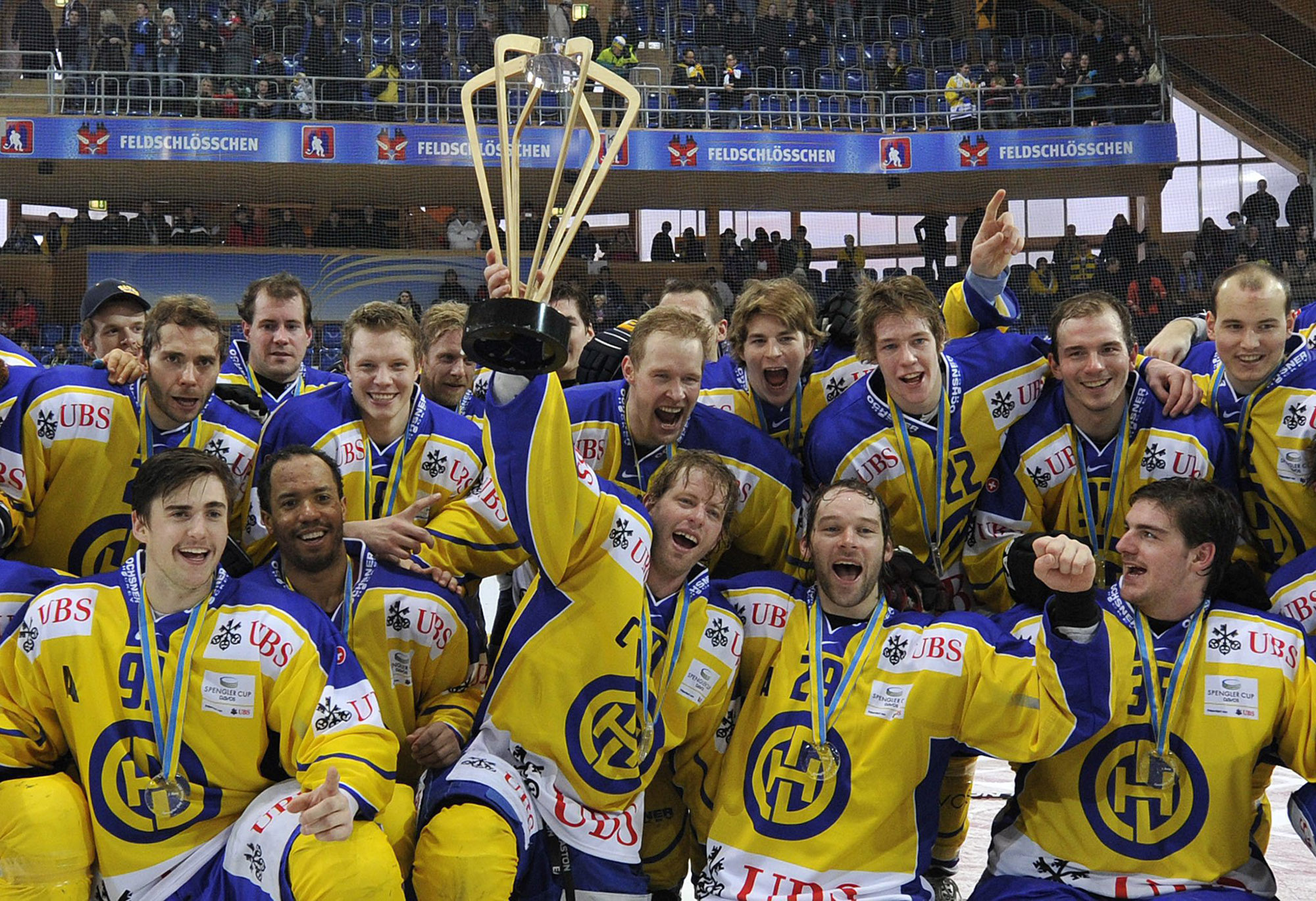 Davos players celebrate their victory after the final game between HC Davos and Dynamo Riga at the 85th Spengler Cup ice hockey tournament, in Davos, Switzerland, Saturday, December 31, 2011. (KEYSTONE/ Peter Schneider)