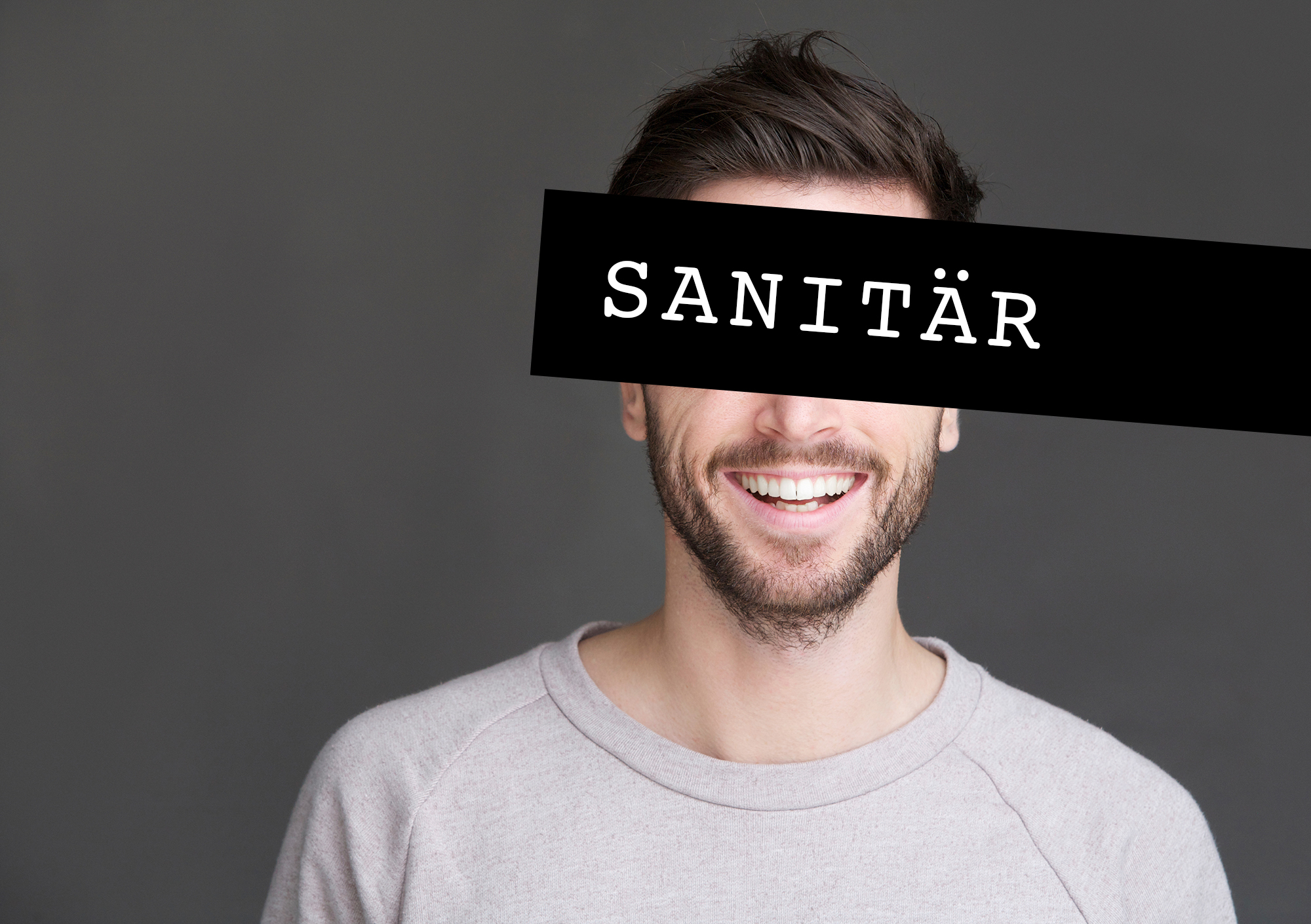 Closeup portrait of a happy young man smiling on gray background