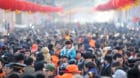 A girl wears a monkey king headwear at a festival fair during Chinese Lunar New Year celebrations in Qingdao, Shandong Provin
