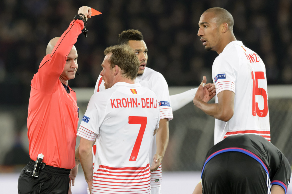 British referee Anthony Taylor, left, gives a red card to Sevilla's Steven N'Zonzi, right, during the UEFA Europa League Round of 16 first leg soccer match between Switzerland's FC Basel 1893 and Spain's Sevilla Futbol Club at the St. Jakob-Park stadium in Basel, Switzerland, on Thursday, March 10, 2016. (KEYSTONE/Laurent Gillieron)