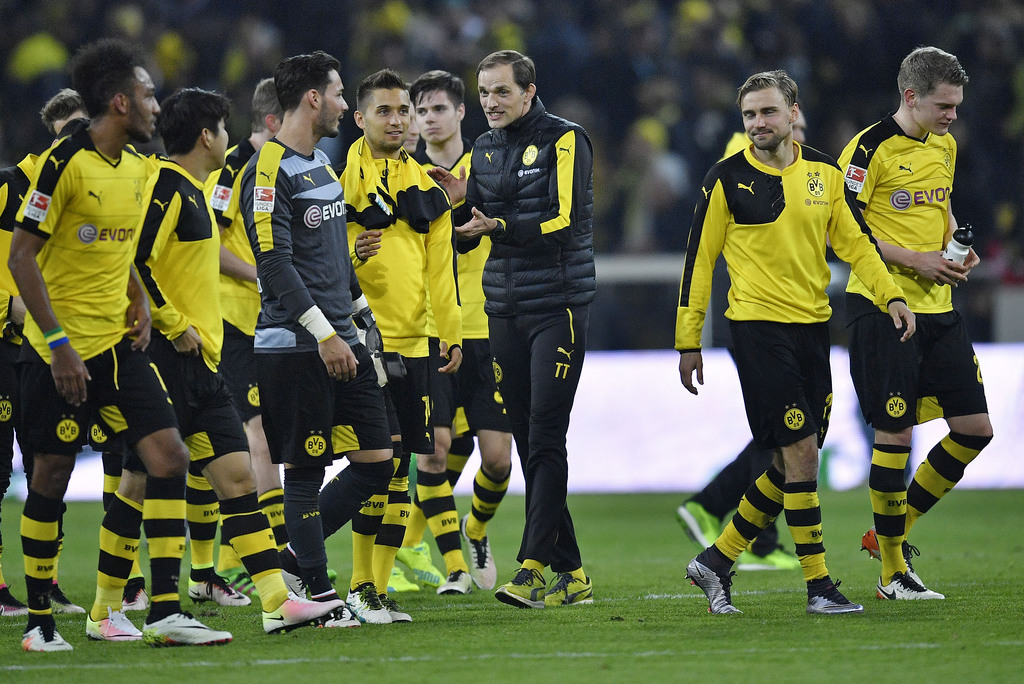 Dortmund head coach Thomas Tuchel congratulates his players after winning the German Bundesliga soccer match between Borussia Dortmund and Werder Bremen in Dortmund, Germany, Saturday, April 2, 2016. Dortmund defeated Bremen in a dramatic match with 3-2. (AP Photo/Martin Meissner)