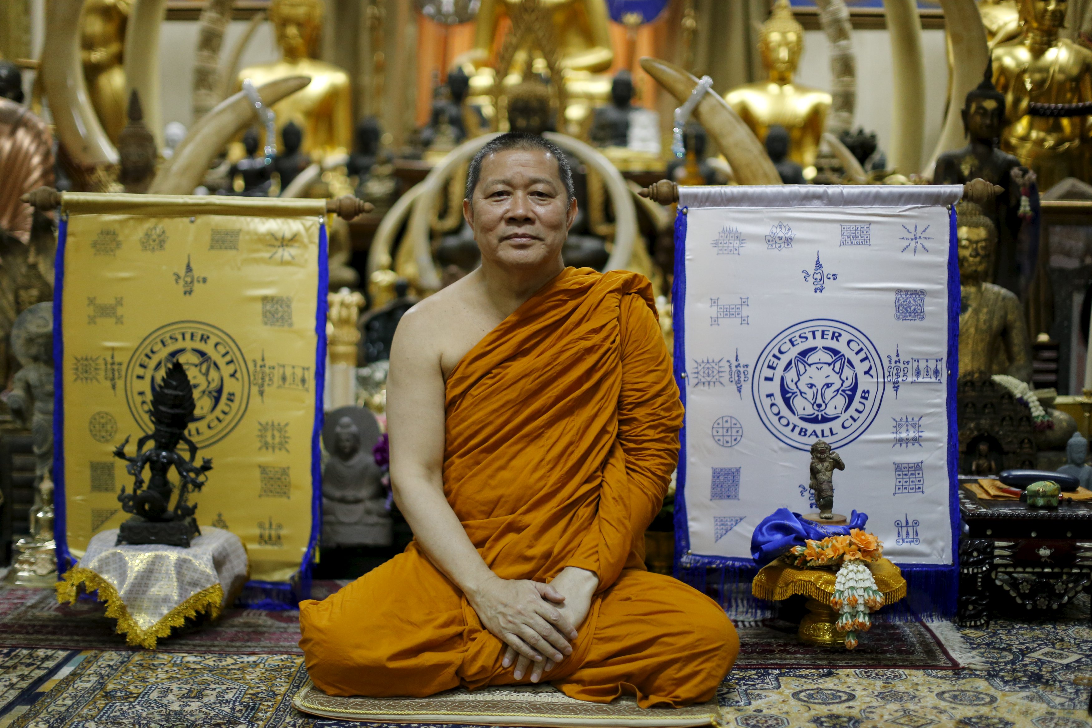 Buddhist monk Phra Prommangkalachan poses for a portrait next to holy cloths with Leicester City's logo while he blesses the team at his temple in Bangkok, Thailand April 18, 2016.  TPX IMAGES OF THE DAY
