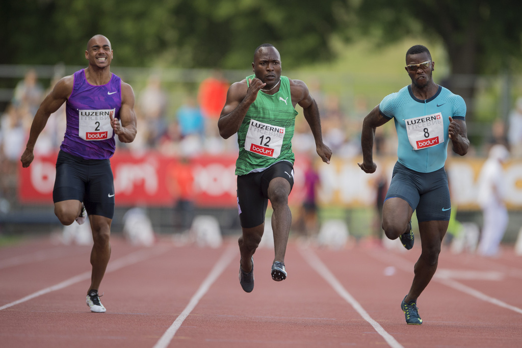 Alex Wilson, centre, Reto Amaru Schenkel, right, and Rolf Malcolm Fongue, left, from Switzerland during the men's 100m race at the International Athletics Meeting in Lucerne, Switzerland, Tuesday, July 14, 2015. (KEYSTONE/Urs Flueeler)