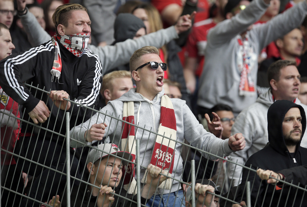 Supporters of Stuttgart shout after the German Bundesliga soccer match between VfL Wolfsburg and VfB Stuttgart in Wolfsburg, Germany, Saturday, May 14, 2016. Wolfsburg defeated Stuttgart by 3-1. (AP Photo/Michael Sohn)