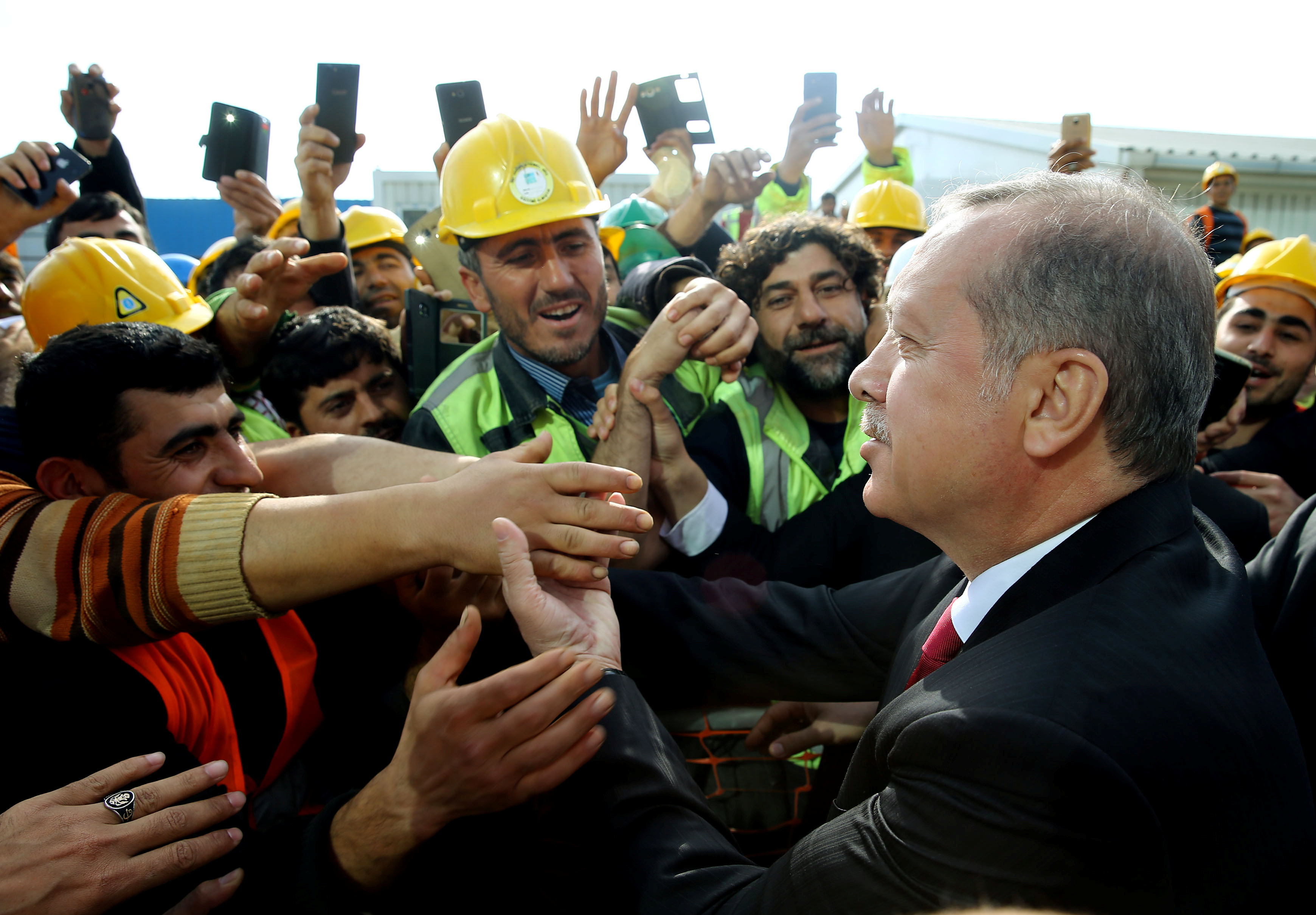 Turkish President Tayyip Erdogan meets with workers during his visit to the construction site of the city's third airport in Istanbul, Turkey May 9, 2016.