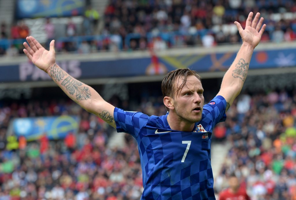 epa05359236 Ivan Rakitic of Croatia reacts during the UEFA EURO 2016 group D preliminary round match between Turkey and Croatia at Parc des Princes in Paris, France, 12 June 2016.....(RESTRICTIONS APPLY: For editorial news reporting purposes only. Not used for commercial or marketing purposes without prior written approval of UEFA. Images must appear as still images and must not emulate match action video footage. Photographs published in online publications (whether via the Internet or otherwise) shall have an interval of at least 20 seconds between the posting.) EPA/GEORGI LICOVSKI EDITORIAL USE ONLY