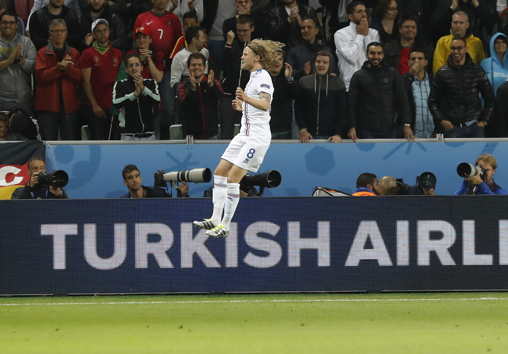 Iceland's Birkir Bjarnason celebrates after scoring his side's first goal during the Euro 2016 Group F soccer match between Portugal and Iceland at the Geoffroy Guichard stadium in Saint-Etienne, France, Tuesday, June 14, 2016. (AP Photo/Laurent Cipriani)