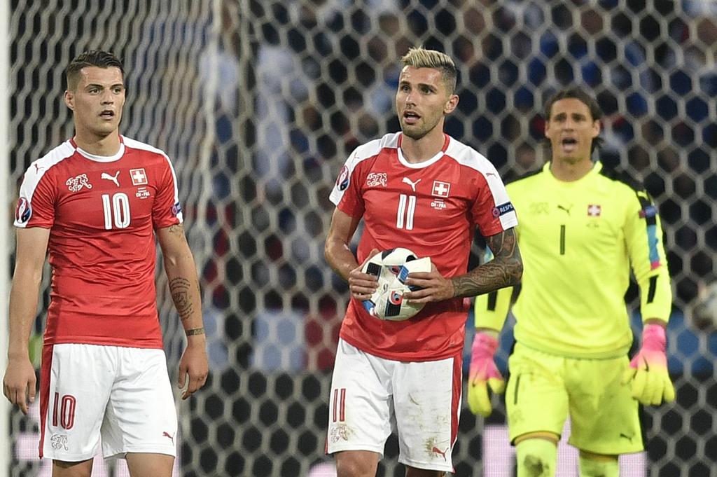 Switzerland's Valon Behrami, holds the ball after it burst during the Euro 2016 Group A soccer match between Switzerland and France at the Pierre Mauroy stadium in Villeneuve d�Ascq, near Lille, France, Sunday, June 19, 2016. (AP Photo/Martin Meissner)