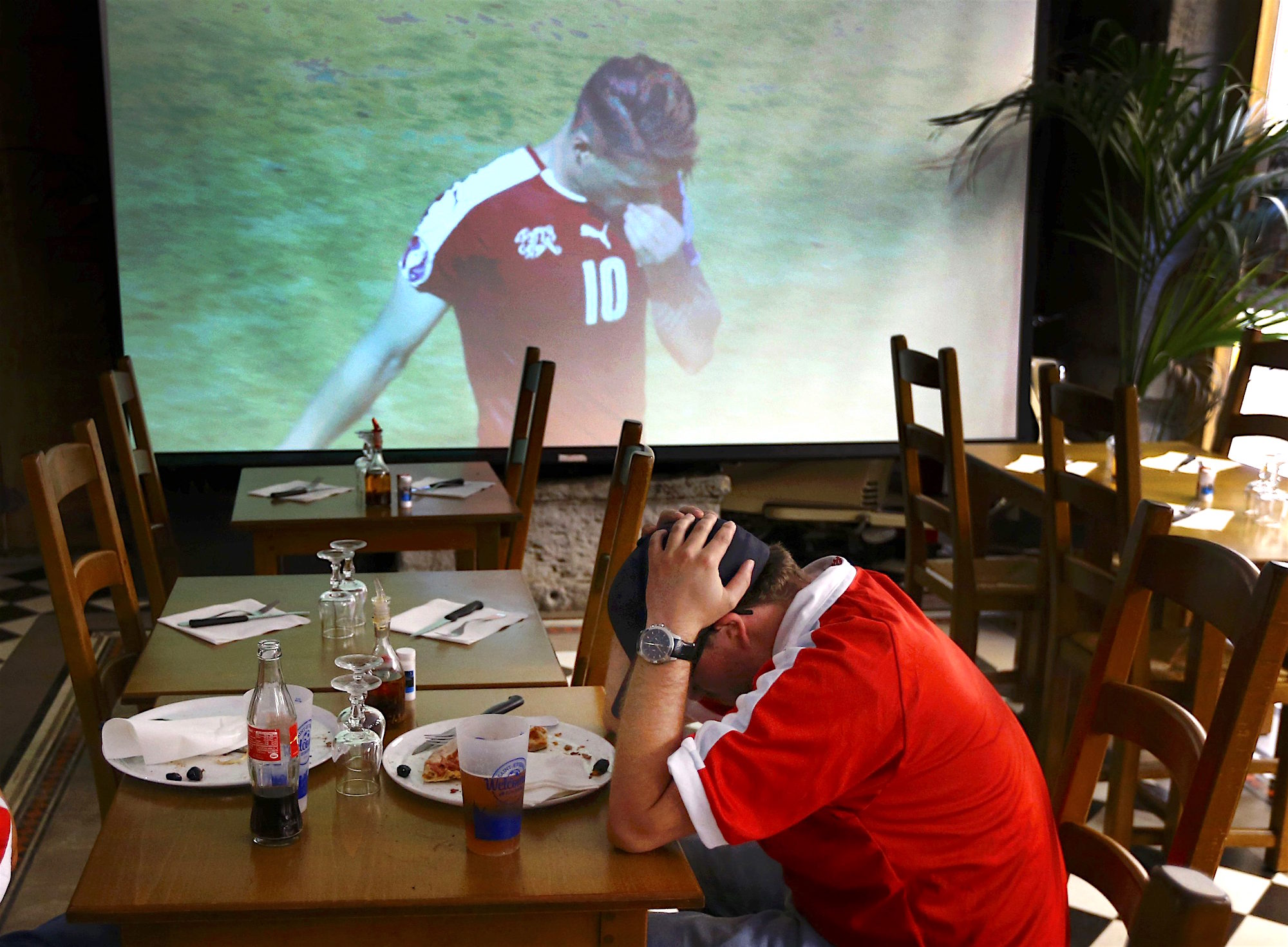 Football Soccer - EURO 2016 - Saint Etienne, France - 25/6/16 - A Switzerland fan reacts to his team losing the Round of 16 match against Poland in Saint Etienne, France. REUTERS/Wolfgang Rattay