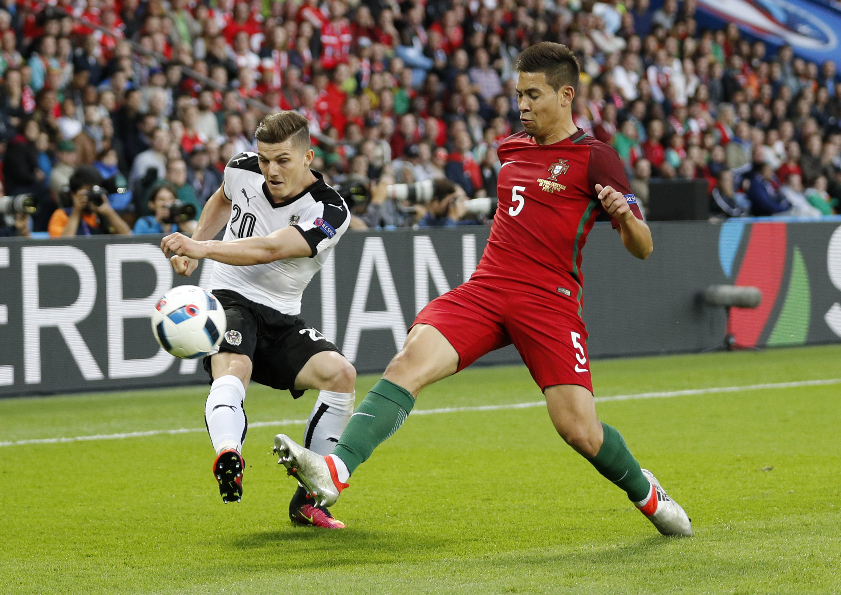 Football Soccer - Portugal v Austria - EURO 2016 - Group F - Parc des Princes, Paris, France - 18/6/16 Portugal's Raphael Guerreiro in action with Austria's Marcel Sabitzer REUTERS/Charles Platiau Livepic