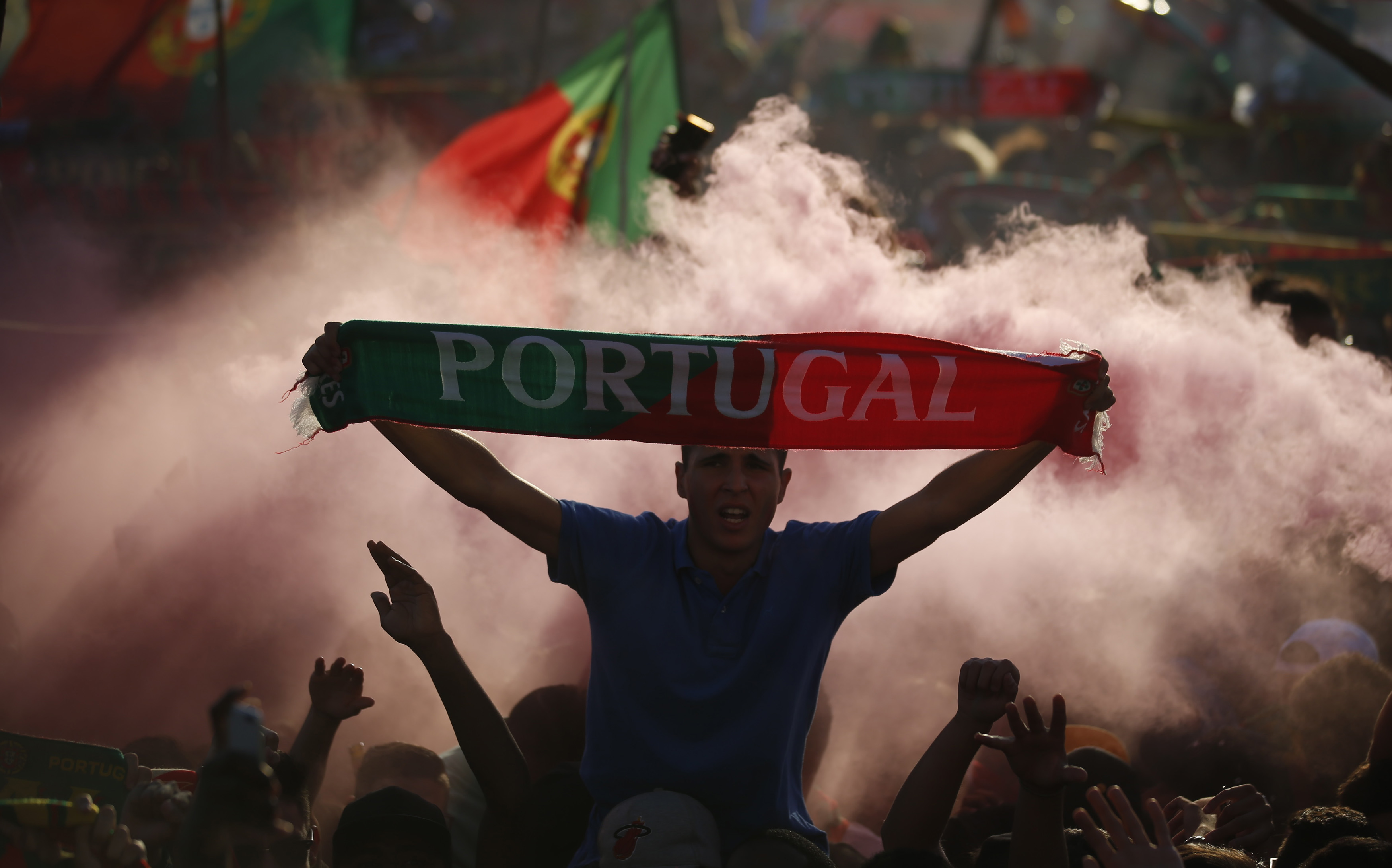 Fans of Portugal react as they watch the Euro 2016 final between Portugal and France at a public screening in Lisbon, Portugal, July 10, 2016. REUTERS/Rafael Marchante