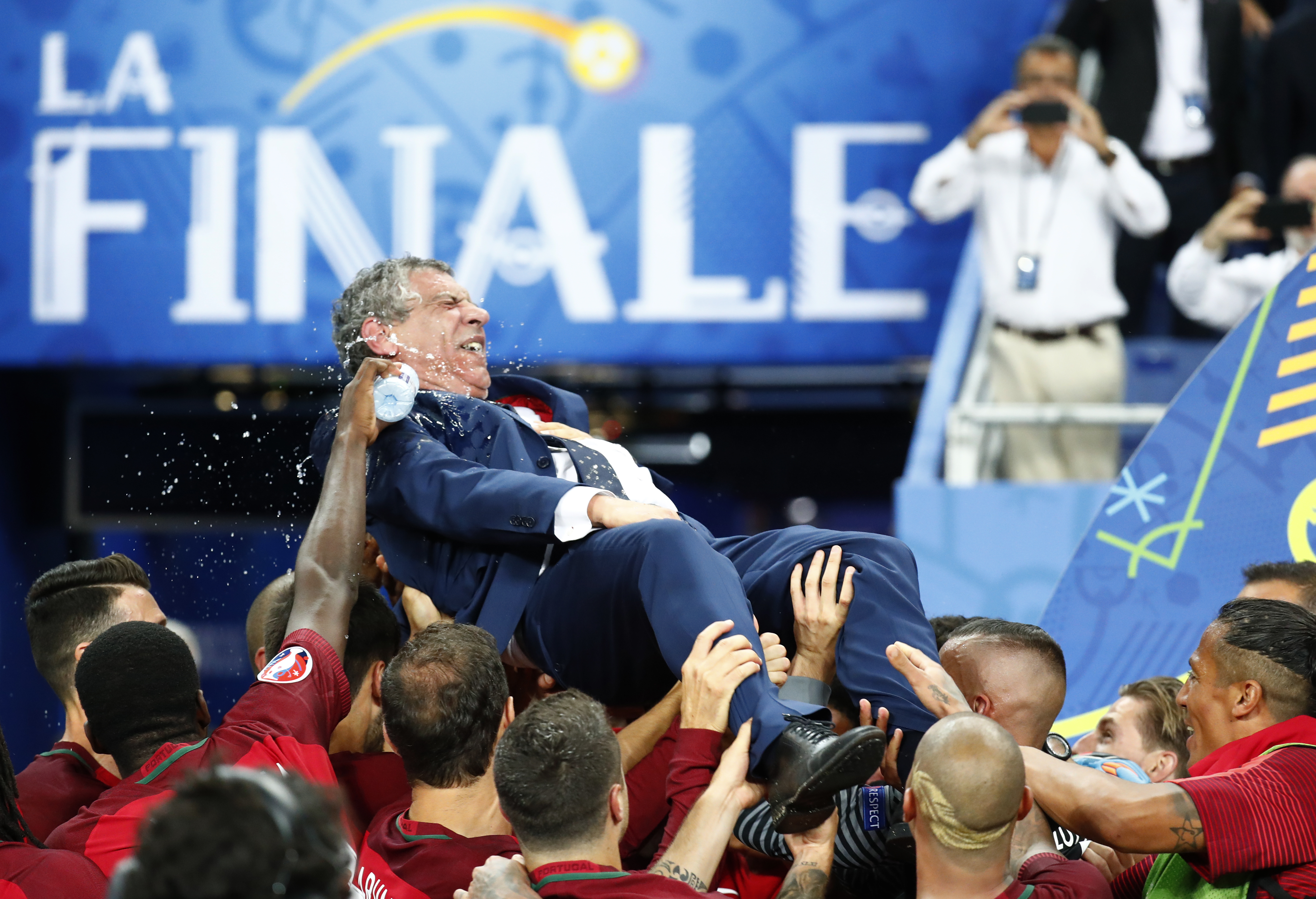 Football Soccer - Portugal v France - EURO 2016 - Final - Stade de France, Saint-Denis near Paris, France - 10/7/16 Portugal head coach Fernando Santos is lifted up by his players after winning Euro 2016 REUTERS/Kai Pfaffenbach Livepic