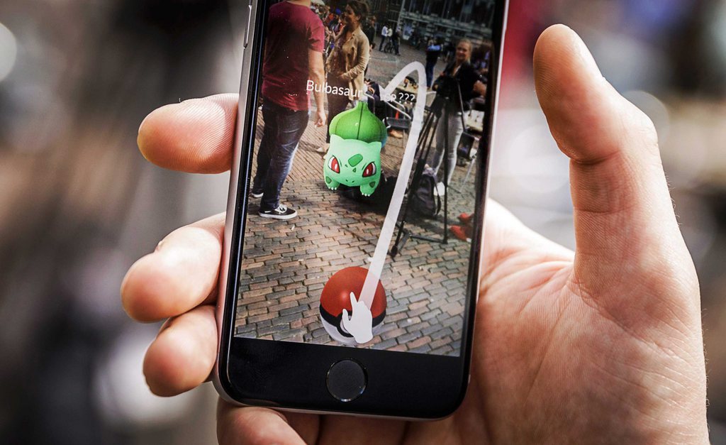 epa05424119 A close-up view of a gamer playing the Pokemon Go app on the Grote Markt in Haarlem, The Netherlands, in an image dated 13 July 2016. The game, that uses the GPS to locate the smartphone's location, has gained a huge popularity among smartphone users and added to the value of Nintendo that partly owns the franchise enterprise that makes Pokemon. EPA/REMKO DE WAAL