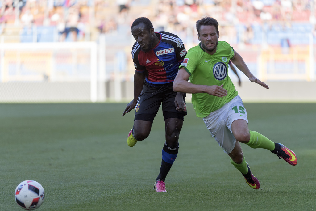 Basel's Seydou Doumbia, left, fights for the ball against Wolfsburg's Christian Traesch, right, during a friendly soccer match between Switzerland's FC Basel 1893 and Germany's VfL Wolfsburg at the St. Jakob-Park stadium in Basel, Switzerland, on Tuesday, July 19, 2016. (KEYSTONE/Georgios Kefalas)