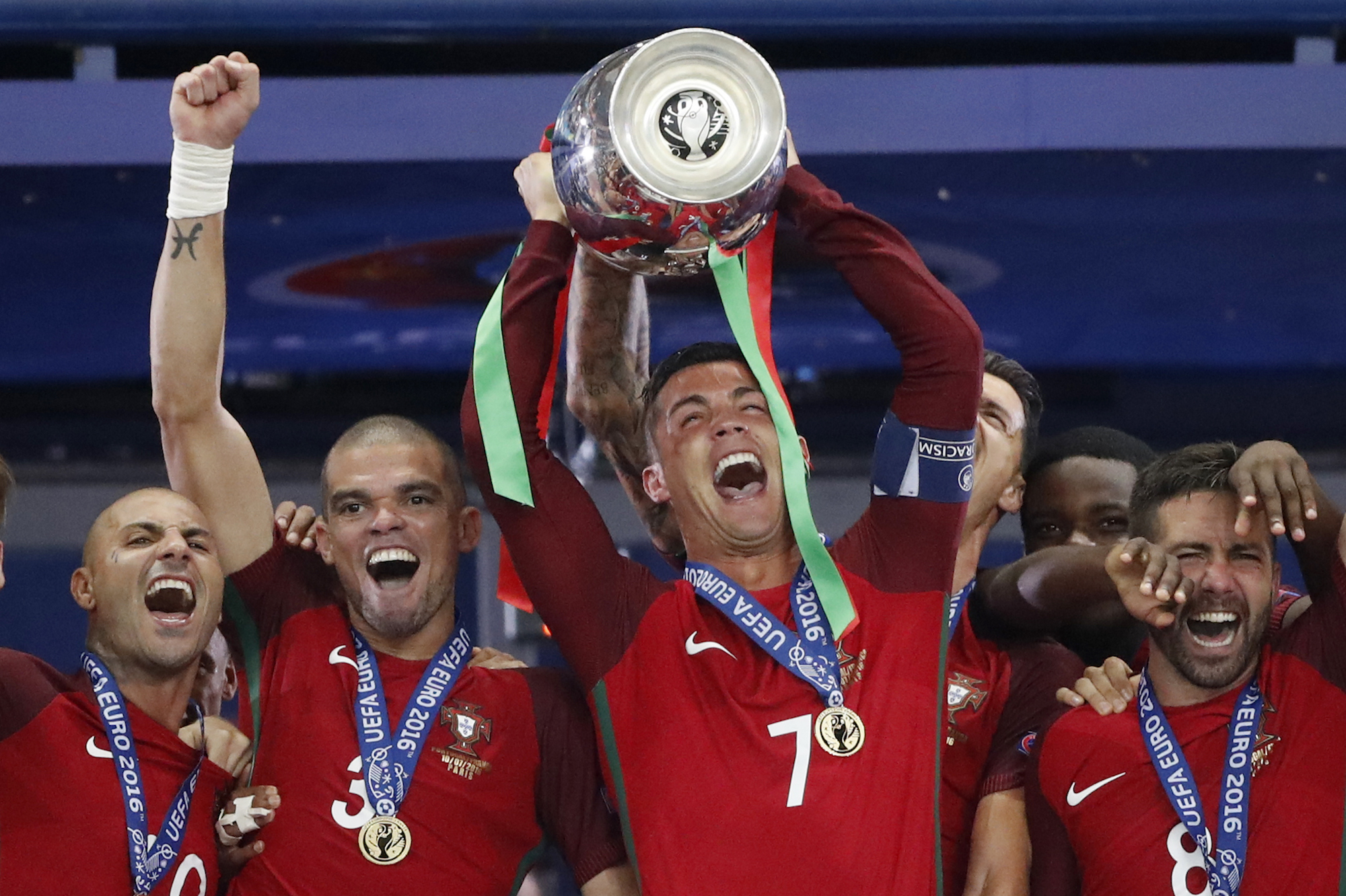 Football Soccer - Portugal v France - EURO 2016 - Final - Stade de France, Saint-Denis near Paris, France - 10/7/16 Portugal's Cristiano Ronaldo celebrates with Pepe, Ricardo Quaresma and Joao Moutinho and the trophy after winning Euro 2016 REUTERS/Carl Recine Livepic