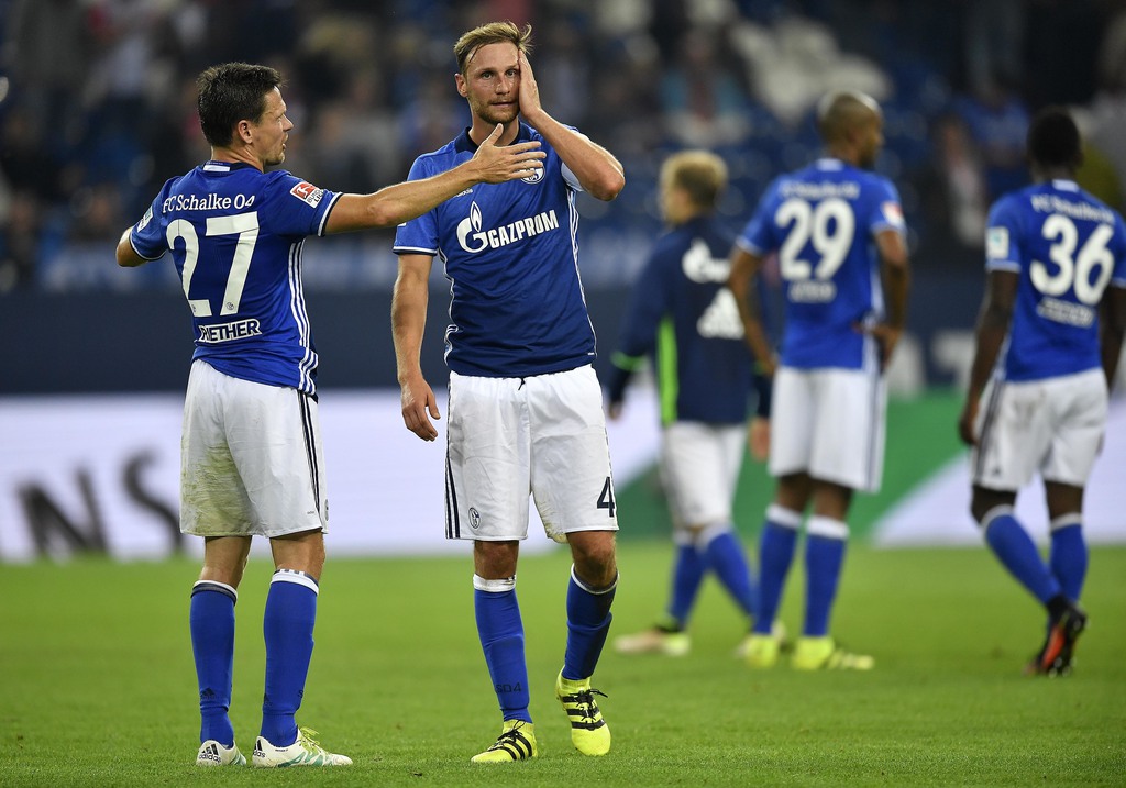 Schalke's Sascha Riether, left, and Schalke's Benedikt Hoewedes stand disappointed after losing the German Bundesliga soccer match between FC Schalke 04 and 1. FC Cologne in Gelsenkirchen, Germany, Wednesday, Sept. 21, 2016. Schalke was defeated by Cologne with 1-3. (AP Photo/Martin Meissner)