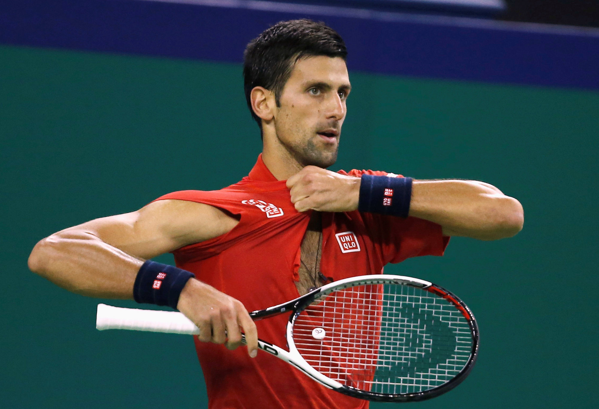 Tennis - Shanghai Masters tennis tournament - Novak Djokovic of Serbia v Roberto Bautista Agut of Spain - Shanghai, China - 15/10/16. Djokovic adjusts his shirt. REUTERS/Aly Song