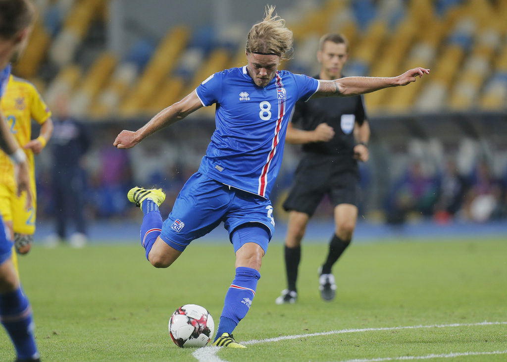Iceland's Birkir Bjarnason shots a ball during World Cup Group I qualifying soccer match between Ukraine and Iceland at the Olympiyskiy stadium in Kiev, Ukraine, Monday, Sept. 5, 2016. (AP Photo/Efrem Lukatsky)
