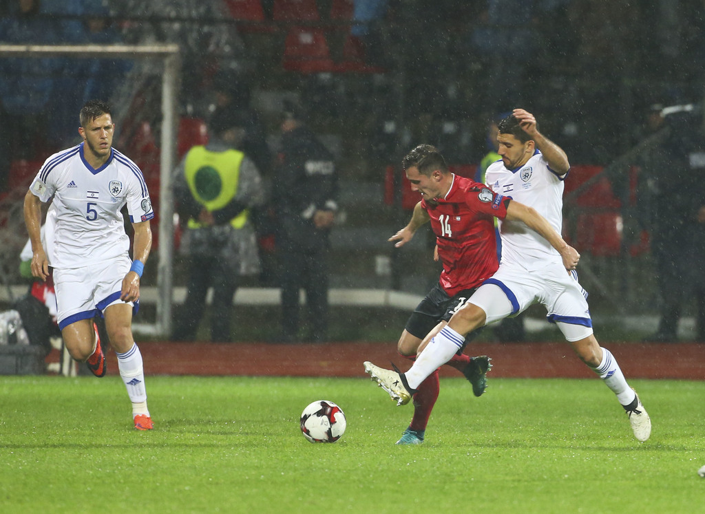 Albania's Taulant Xhaka,second right, fights for the ball with Israel's Daniel Einbinder, during the World Cup Group G qualifying soccer match between Albania and Israel, at Elbasan Arena stadium, in Elbasan, Albania, Saturday, Nov. 12, 2016. (AP Photo/Hektor Pustina)