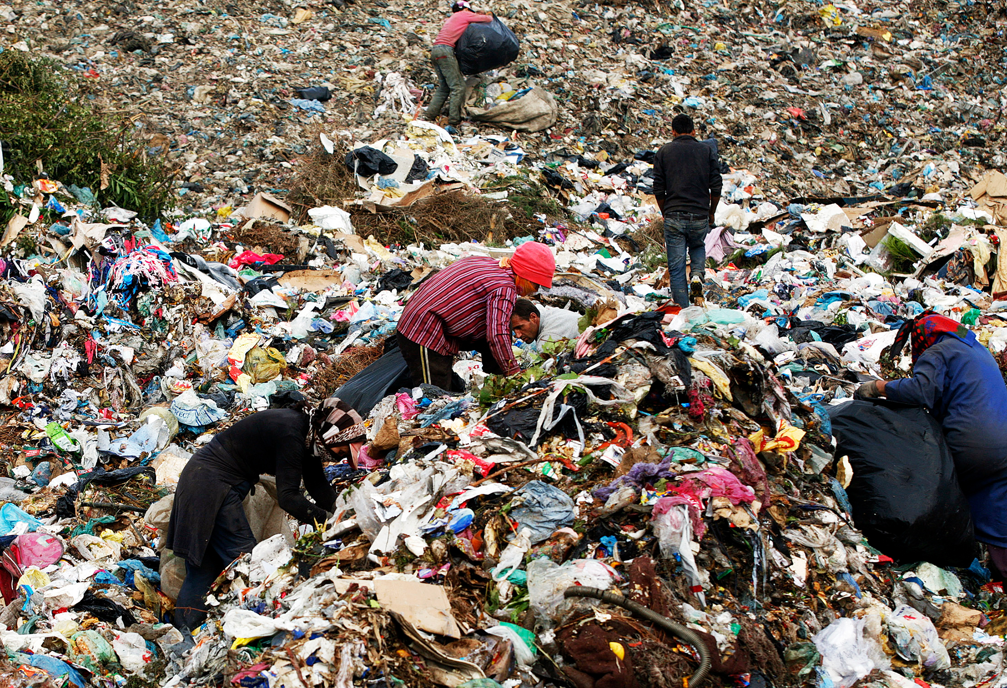 People search a garbage dump outside Albania?s capital Tirana October 27, 2011. A law by Albania?s government to allow imports of waste from abroad is meeting with increasing opposition from youth groups and the political opposition. REUTERS/Arben Celi (ALBANIA - Tags: SOCIETY) - RTR2TAJ5
