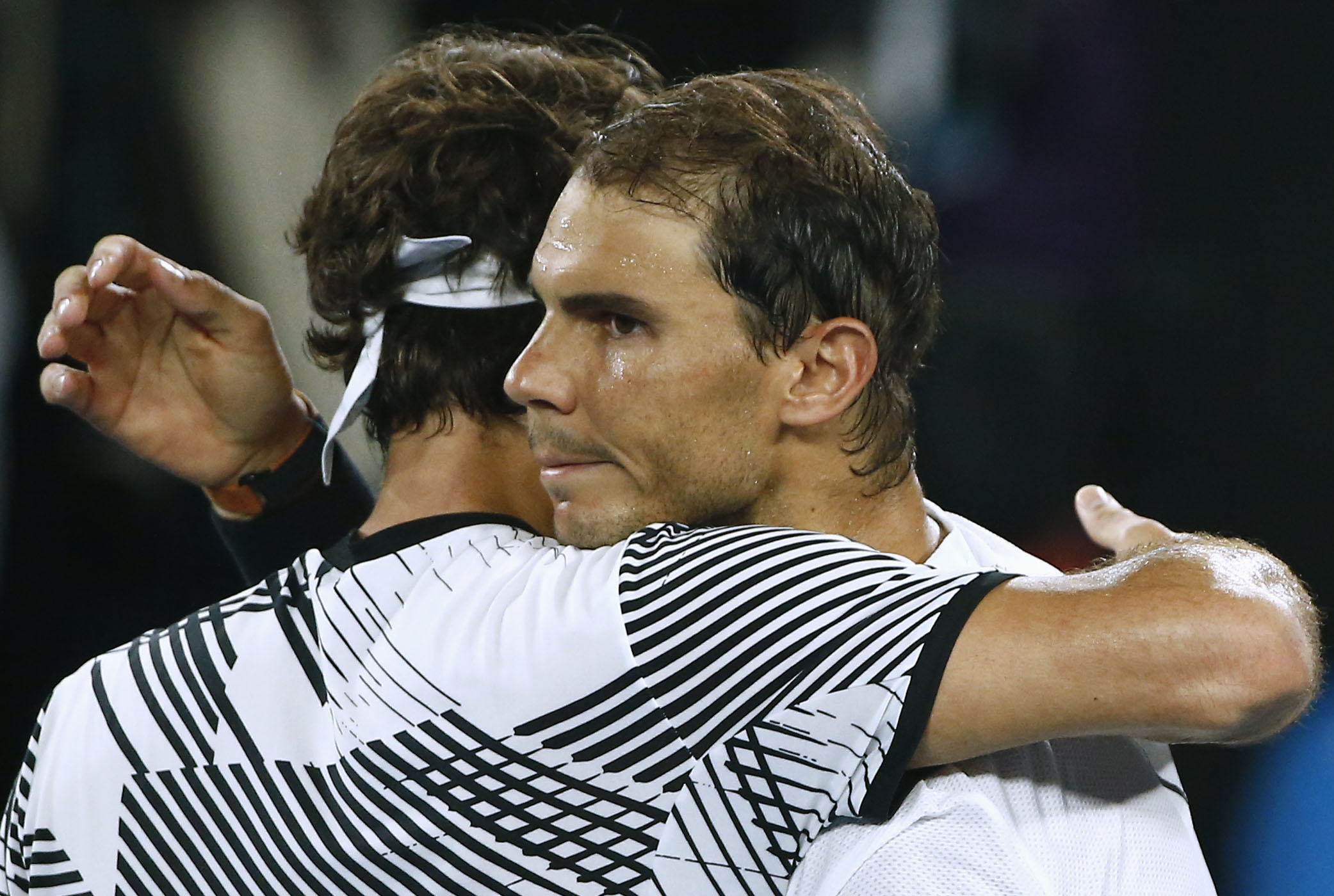 Tennis - Australian Open - Melbourne Park, Melbourne, Australia - 29/1/17 Switzerland's Roger Federer embraces after winning his Men's singles final match against Spain's Rafael Nadal. REUTERS/Thomas Peter