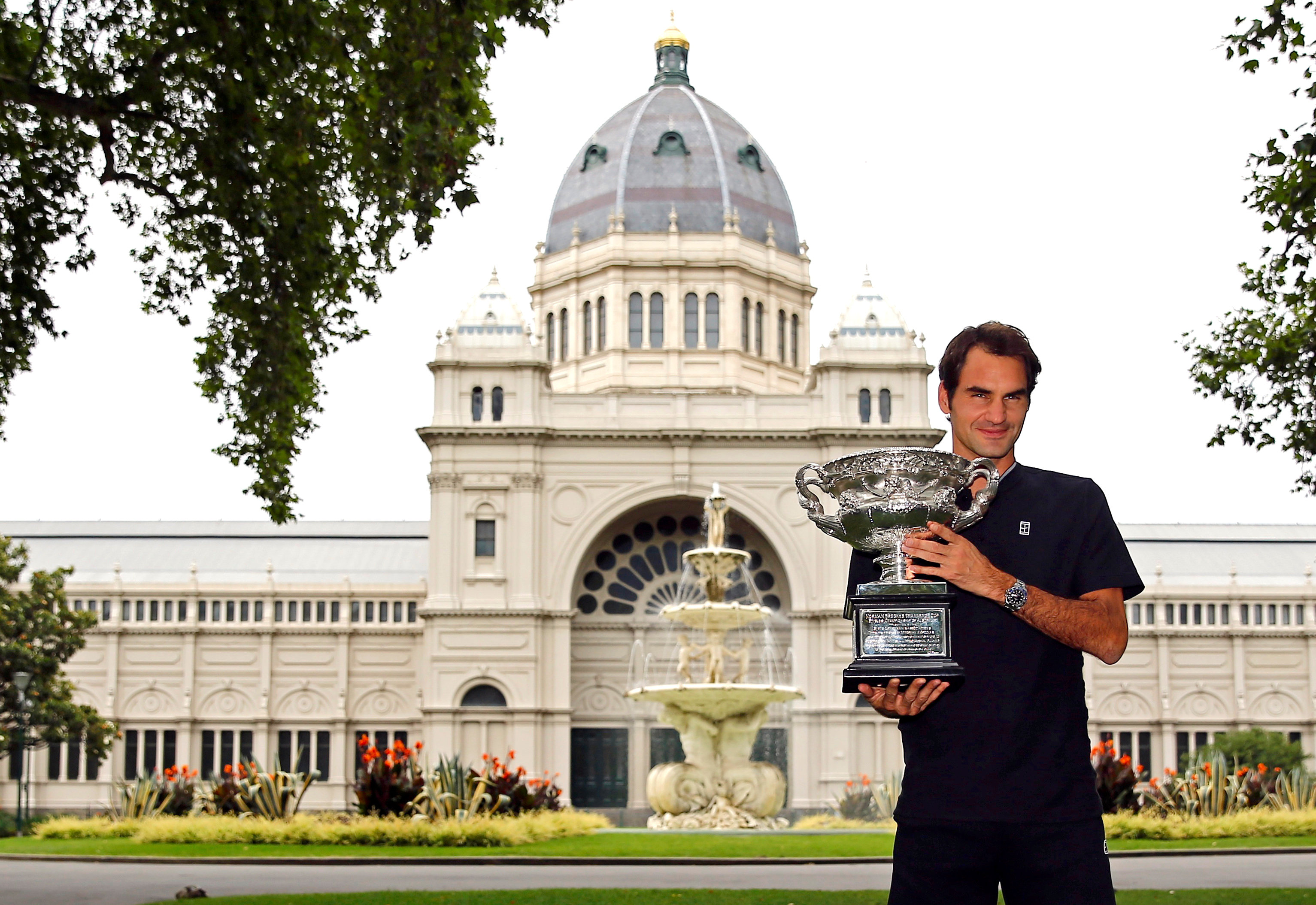 Switzerland's Roger Federer holds the trophy during a photo call the morning after he won the Men's singles final at the Australian Open tennis tournament in Melbourne, Australia January 30, 2017. REUTERS/Thomas Peter