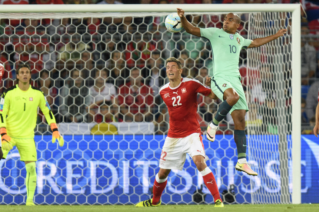 Swiss goalkeeper Yann Sommer, left,and Swiss defender Fabian Schaer, center, fights for the ball with Portugal's midfielder Joao Mario, right, during the 2018 Fifa World Cup Russia group B qualification soccer match between Switzerland and Portugal at the St. Jakob-Park stadium, in Basel, Switzerland, Tuesday, September 6, 2016. (KEYSTONE/Jean-Christophe Bott).