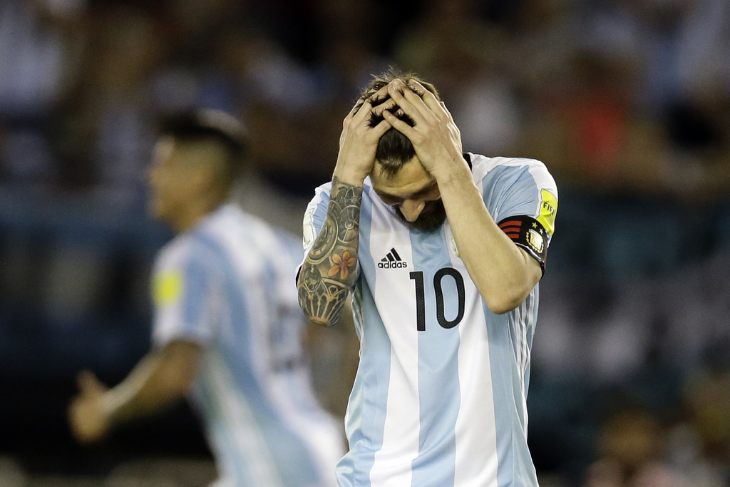In this March 23, 2017 photo, Argentina's Lionel Messi reacts after missing a chance to score during a World Cup qualifying match against Chile in Buenos Aires, Argentina. Messi has been banned from Argentina's next four World Cup qualifiers, starting with the Tuesday, March 28, 2017 game in Bolivia, for 