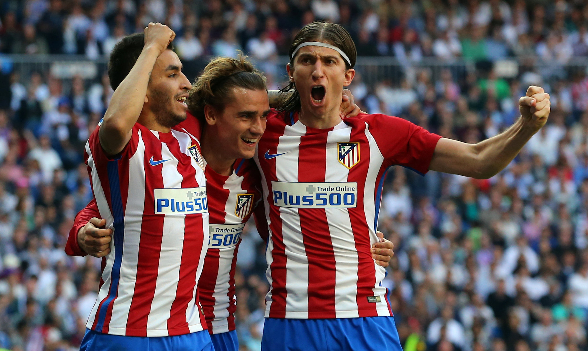 Football Soccer - Real Madrid v Atletico Madrid - Spanish La Liga Santander - Santiago Bernabeu Stadium, Madrid, Spain - 8/04/17 - Atletico Madrid's Antoine Griezmann (C) celebrates a goal with his teammates Angel Correa (L) and Filipe Luis. REUTERS/Juan Medina