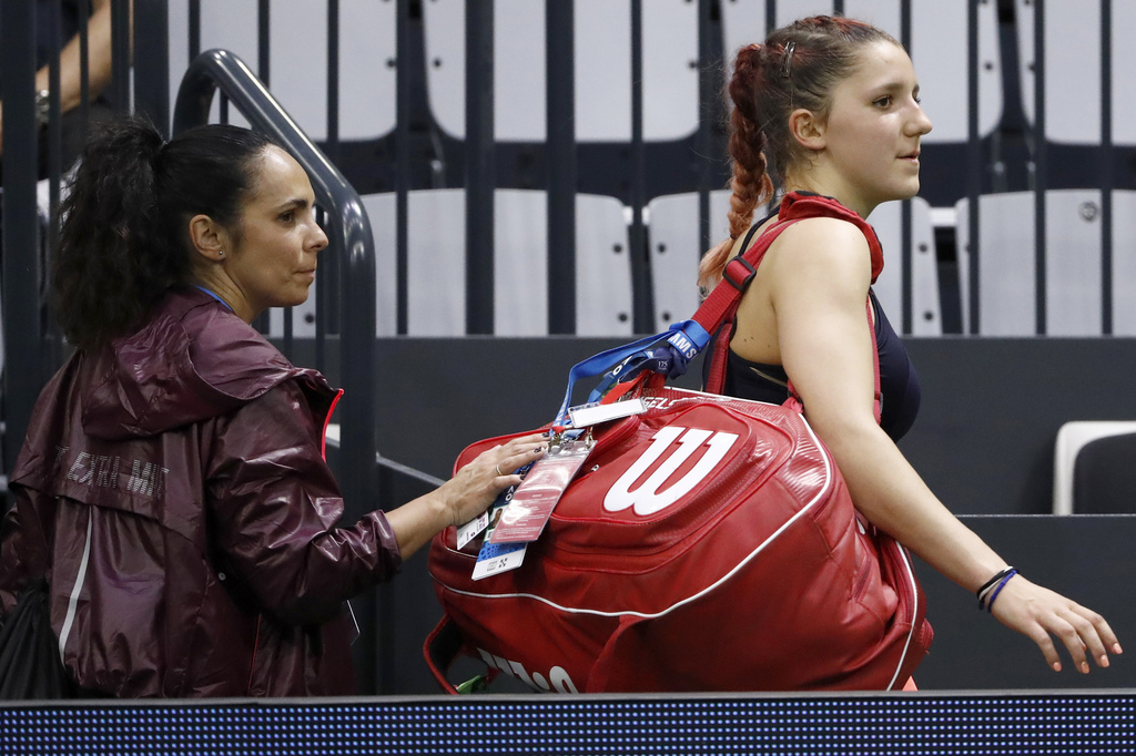 Rebeka Masarova of Switzerland leaves the center court with her coach Maria Victoria Vieites after losing her first round match against Annika Beck of Germany, at the WTA Ladies Open tennis tournament in Biel, Switzerland, Monday, April 10, 2017. (KEYSTONE/Peter Klaunzer)