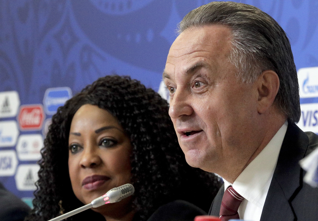 Russian Deputy Prime Minister and Russia World Cup head Vitaly Mutko is flanked by FIFA secretary general Fatma Samoura, left, during a news conference at the St. Petersburg Stadium, Russia, Friday, June 16, 2017. (AP Photo/Dmitri Lovetsky)