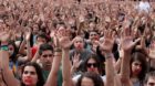 People raise their hands during a protest the day after the banned independence referendum in Barcelona, Spain October 2, 201
