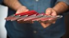 A man holds Swiss passports in his hands, photographed on December 2, 2016. (KEYSTONE/Christian Beutler) 

Ein Mann haelt Sch