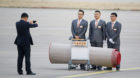 Staff have their picture taken with the carpet they rolled out for the arrival of U.S. President Donald Trump and first lady 