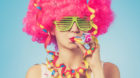 Portrait of beautiful woman in pink wig and green glasses. Close up