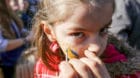 Kosovo flag is being painted on girl's face during celebrations of the 10th anniversary of Kosovo's independence in Pristina,