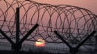 The sun rises over a barbed-wire fence at a military check point on the Unification Bridge, linked to North Korea, near the d