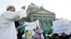 An unidentified Imam speaks in front of the house of parliament during a demonstration in Berne, February 11, 2006. The prote