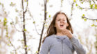 Girl having allergy outdoor. The girl sneezes