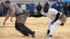 Senegalese wrestler Dieylani Pouye (R) holds an opponent during a fight at a qualification tournament in Romont May 26, 2013.