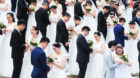 HANGZHOU, CHINA - APRIL 21: Newly-wed couples attend a group wedding ceremony before International Workers Day on April 21, 2