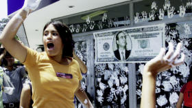 Peruvian students daub handprints in white paint on the glass doors of a branch of Banco de Credito in Lima, Peru's biggest b